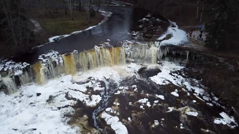 Aerial-drone-view-of-a-frozen-waterfall-in-North-Europe