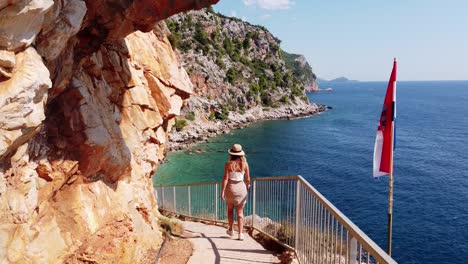 Girl-walking-the-stairs-to-hidden-Pasjaca-Beach-in-Dalmatia,-Croatia---Aerial-Drone-View