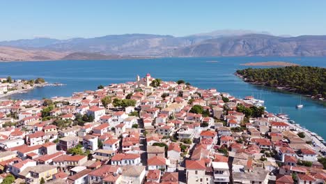 Galaxidi,-Fokida,-Greece---Aerial-Drone-View-of-the-Picturesque-Marine-Village,-Harbour,-Church,-Blue-Sea-and-Mountains