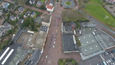 Aerial-of-small-street-in-typical-Dutch-town-leading-to-a-busy-roundabout