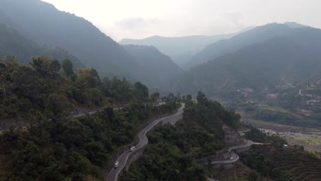 Drone-view-of-traffic-on-the-BP-Highway,-Bardibas-Highway,-in-the-mountains-of-Nepal