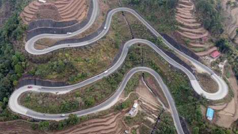 Timelapse-aerial-view-of-the-traffic-on-the-BP-Highway,-Bardibas-Highway,-as-it-winds-through-the-rugged-hills-of-Nepal