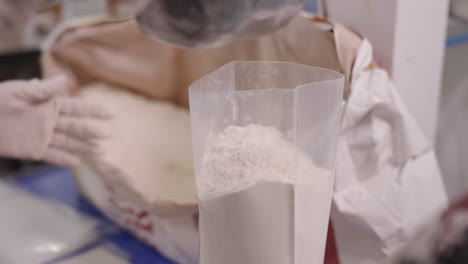 Measure-and-Weighting-White-Wheat-Flour,-Portioning-Flour-in-Plastic-Bag,-Packaging-of-Wheat-Flour