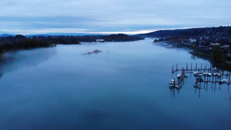 Aerial-Drone-Moving-Forward-above-Willamette-River-at-dusk,-Portland-Oregon