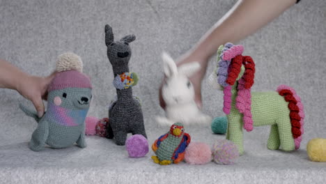 Handmade-knitted-teddy-bears-and-different-animals,-against-grey-background
