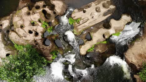 Aerial-top-down-natural-forest-landscape-with-rocky-river-stream-and-waterfall
