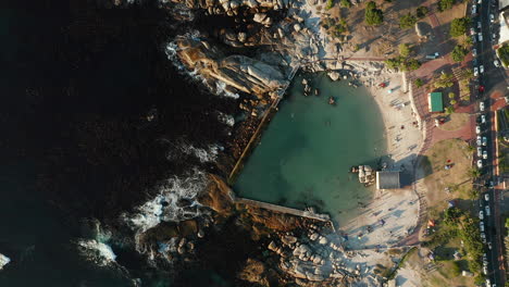 Aerial-View-Of-Camps-Bay-Tidal-Pool-In-Cape-Town,-South-Africa-On-A-Sunny-Day