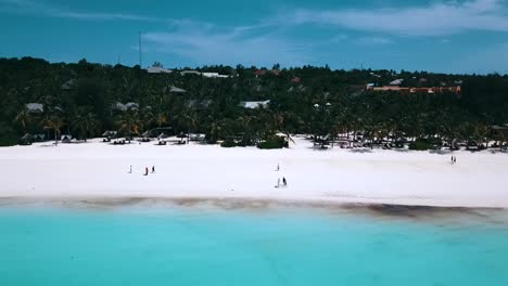 Fantastic-aerial-flight-fly-forwards-drone-shot-Dream-white-sand-beach-over-crystal-clear-turquoise-water