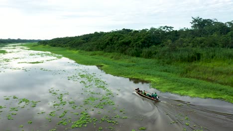Boat-on-Exotic-Amazon-River-in-Lush-Peru-Rainforest-Jungle---Aerial