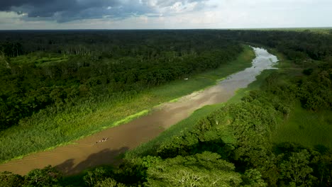 Boat-Traveling-the-Exotic,-Lush-Amazon-River-in-Peru-Rainforest---Aerial