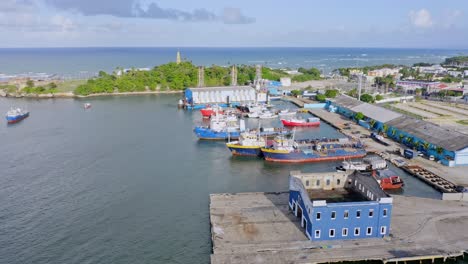 Aerial-flyover-fishing-and-freight-port-with-docking-ships-in-Puerto-Plata,Dominican-Republic