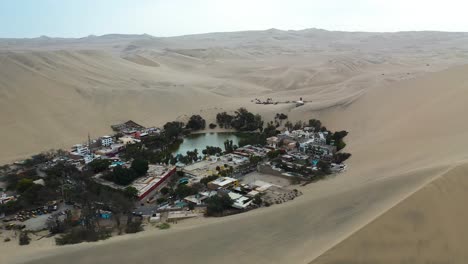 Huacachina-Village-in-Desert-Oasis-of-Peru-Sand-Dunes---Aerial