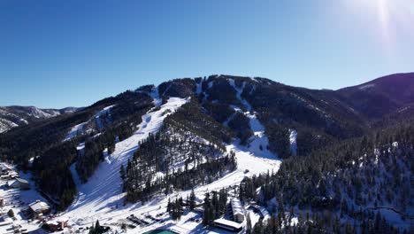 Aerial-drone-shot-of-ski-runs-in-the-mountains-with-pine-trees