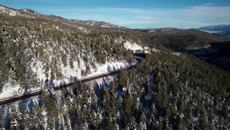 Aerial-drone-shot-of-a-highway-that-wraps-around-the-side-of-a-mountain