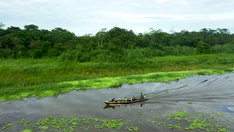 Wooden-Boat-with-Peruvian-People-Traveling-on-Amazon-River---Aerial