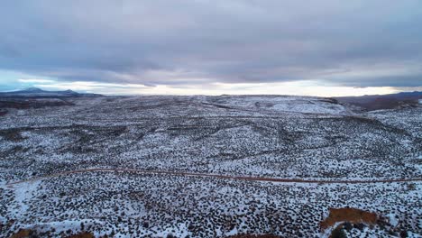 Aerial-drone-shot-over-the-snowy-desert-on-a-cloudy-day-in-Utah
