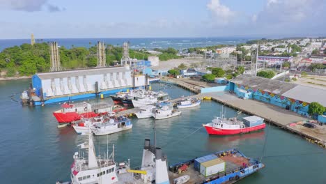 Different-sized-vessels-docked-at-Puerto-Plata-port,-Caribbean-coastline