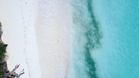 1-million-$-aerial-flight-drone-camera-pointing-down-drone-rocket-shot-strait-up-crystal-clear-turquoise-water-on-a-white-sand-beach-Zanzibar,-africa-2019-Cinematic-filmed-1080,-60p-at-Philipp-Marnitz