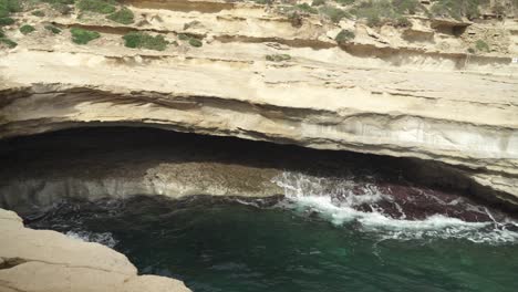 Mediterranean-Sea-Waves-Rushes-Back-and-Forth-in-St-Peter’s-Pool-Stone-Beach-Cave