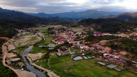 Laos-Ban-That-Hium-village,-drone-fly-above-remote-area-of-Asia-with-wild-nature-and-green-unpolluted-landscape