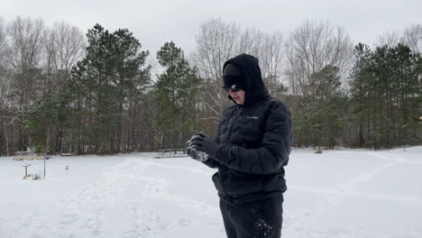 POV-Shot-of-teenager-throwing-a-snowball-directly-at-the-camera