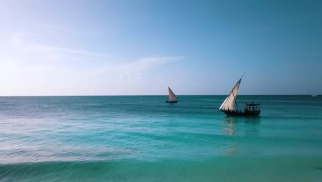 Gorgeous-aerial-flight-of-a-sailing-boat-with-white-sail-on-crystal-clear-turquoise-water
nic-wave-on-white-sand-dream-beach-in-paradise-Zanzibar,-Africa-2019