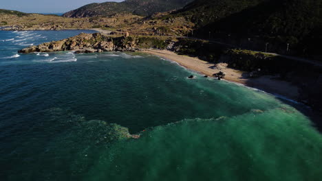 Aerial,-ocean-trash-pollution-gathered-on-current-at-coastal-beach