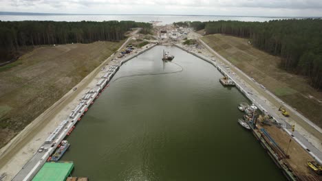 Aerial-dolly-shot-over-the-huge-infrastructure-project---the-Vistula-Spit-canal,-shipping-channel-for-container-ships