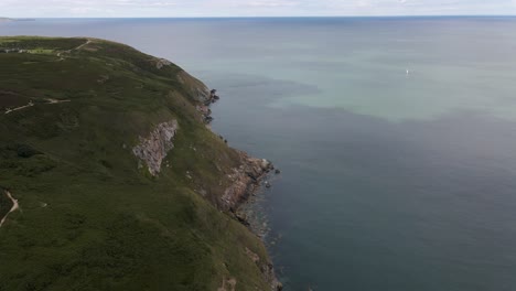 Drone-shot-of-sea-cliffs-on-a-sunny-day