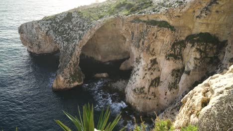 Panoramic-View-of-Blue-Grotto-Sea-Caves-Being-Washed-with-Waves-of-Mediterranean-Sea