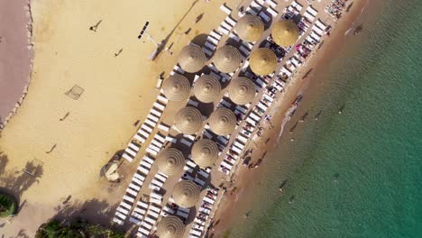 Aerial-view-of-people-taking-sun-on-loungers-and-swim-in-a-beach-at-the-Red-Sea-in-Eilat-city,-south-Israel