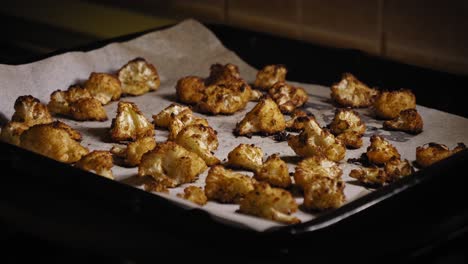 Person-Placing-Baking-Sheet-with-Roasted-Cauliflower-on-Table---Steady-Shot