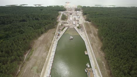 Aerial-descending-shot-of-the-huge-infrastructure-project---the-Vistula-Spit-canal,-shipping-channel-for-container-ships