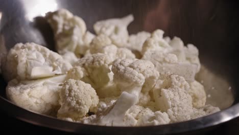 Close-up-View-of-Cauliflower-Being-Seasoned-With-Salt,-Spices-and-Oil---Steady-Shot