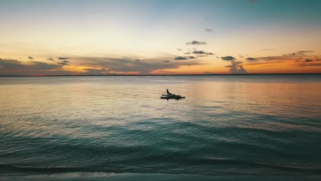 Spectacular-slow-motion-aerial-flight-drone-shot-at-sunset-of-yoga-girl-on-stand-up-board