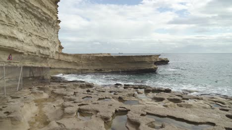 Holes-Formed-in-Stone-Ground-Filled-With-Water-in-St-Peter’s-Pool-Stone-Beach-in-Malta
