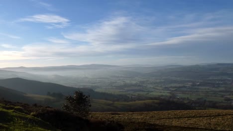 Distant-misty-layers-of-panoramic-rural-Moel-Famau-mountain-valley-countryside-at-dreamlike-sunrise