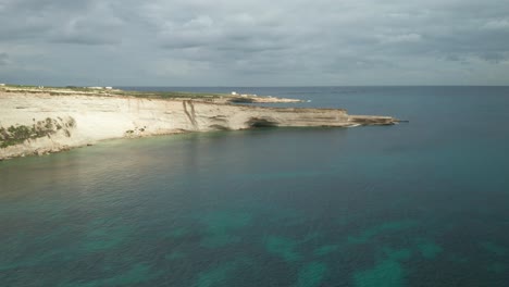 AERIAL:-Ta-Kalanka-Sea-Cave-on-Stormy-Cloudy-Sky-and-Beautiful-Turquoise-Color-Water