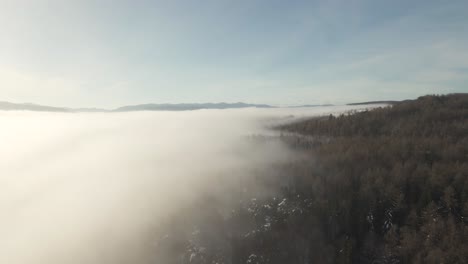 Foggy-Clouds-Blanketing-Ukraine's-Cold,-Snowy-Mountains---Aerial