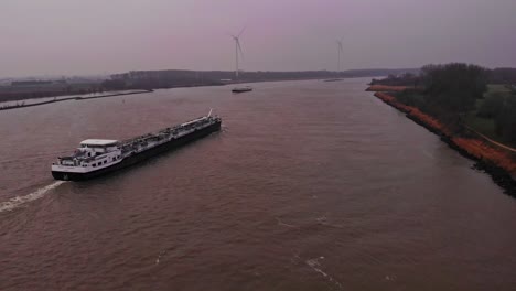 Aerial-View-Of-Tanker-Ship-Travelling-Along-Oude-Maas-On-Overcast-Day