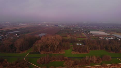 Aerial-View-Of-Agriculture-Farmland-In-Barendrecht-With-Pan-Left-Reveal-Over-Oude-Maas-On-Foggy-Morning