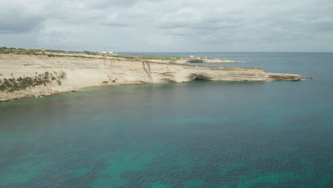AERIAL:-Ta-Kalanka-Sea-Cave-in-Il-Hofra-l-Kbira-Bay-During-Winter-in-Malta