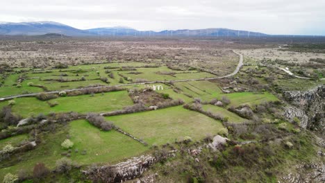 A-wide-overhead-aerial-of-the-stone-arches-of-the-ancient-ruins-of-Burnum,-an-archaeological-site-that-used-to-be-a-Roman-Legion-camp-and-town-near-Krka-National-Park-in-Dalmatia,-Croatia