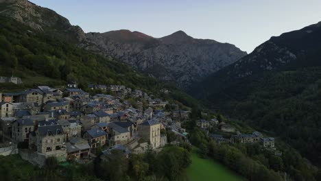 Aerial-drone-footage-flying-near-a-historical-village-nestled-in-the-Pyrenees-Mountains-of-Spain