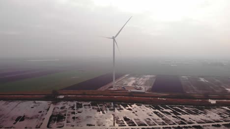 Aerial-View-Of-New-Single-Wind-Turbine-Seen-Through-Morning-Fog-In-Fields-In-Barendrecht
