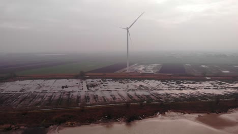 Aerial-View-Of-New-Wind-Turbine-Seen-Through-Morning-Fog-In-Farm-Fields-In-Barendrecht