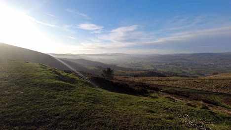 Distant-misty-layers-of-panoramic-rural-mountain-valley-countryside-at-sunrise-timelapse