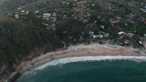 Aerial-bird's-eye-view-of-the-scenic-Mazunte-beach-in-the-oaxacan-coast-in-Mexico-on-a-cloudy-day