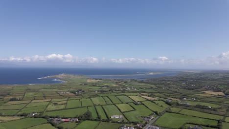 Drone-shot-of-Irish-country-side-and-the-ocean-in-the-background