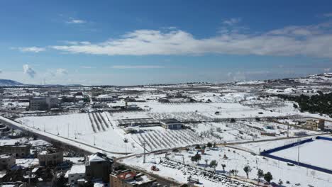 Soccer-fields-and-vineyards-covered-in-white-snow-in-the-city-of-Baquala-in-the-winter-landscape-on-a-partly-cloudy-day